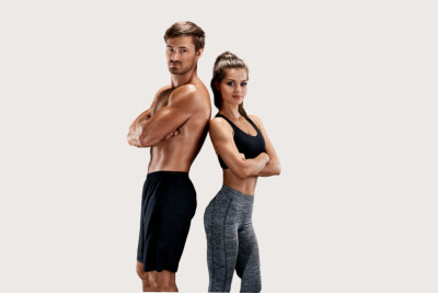 a muscular man and a slim women both standing