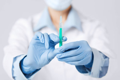 close up of female doctor holding syringe