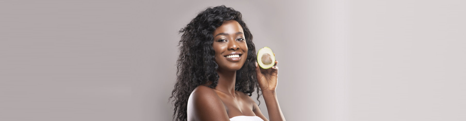 beautiful woman holding an avocado